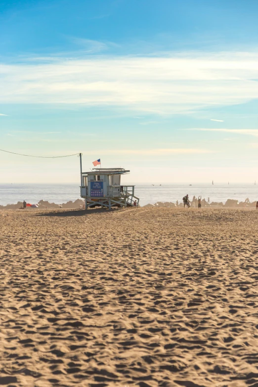 a small building on a beach in the middle of the ocean