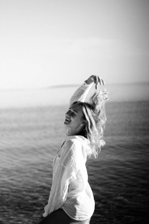 a woman that is standing in front of the ocean