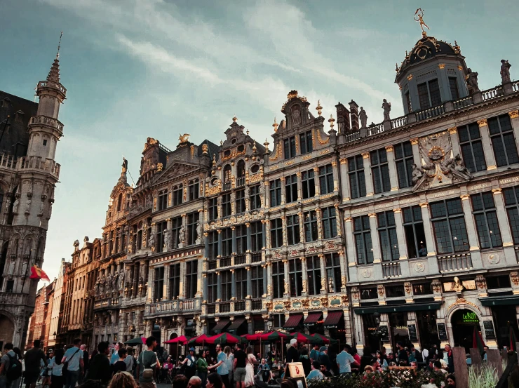 several buildings and people in a courtyard during the day