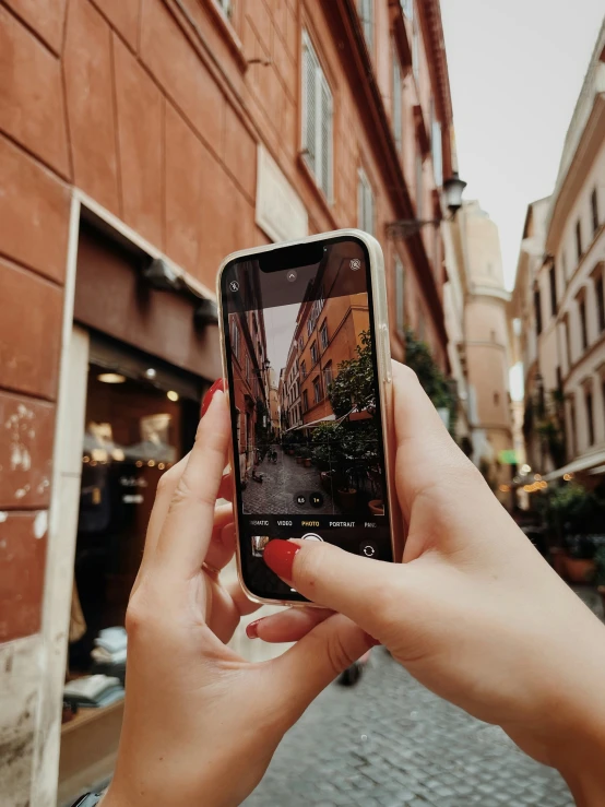 someone holding a cell phone that is on their hand