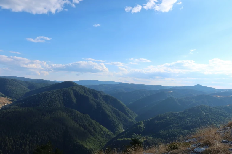 the mountains are covered in green plants