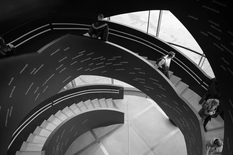 a man climbing up the spiral staircase of a building