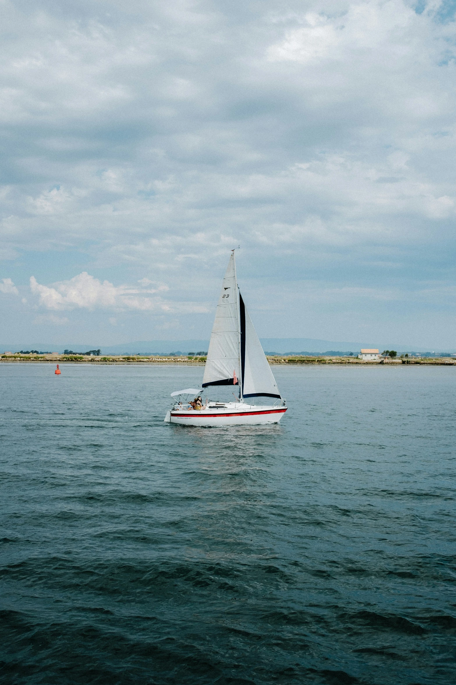 a white boat is in the middle of a body of water