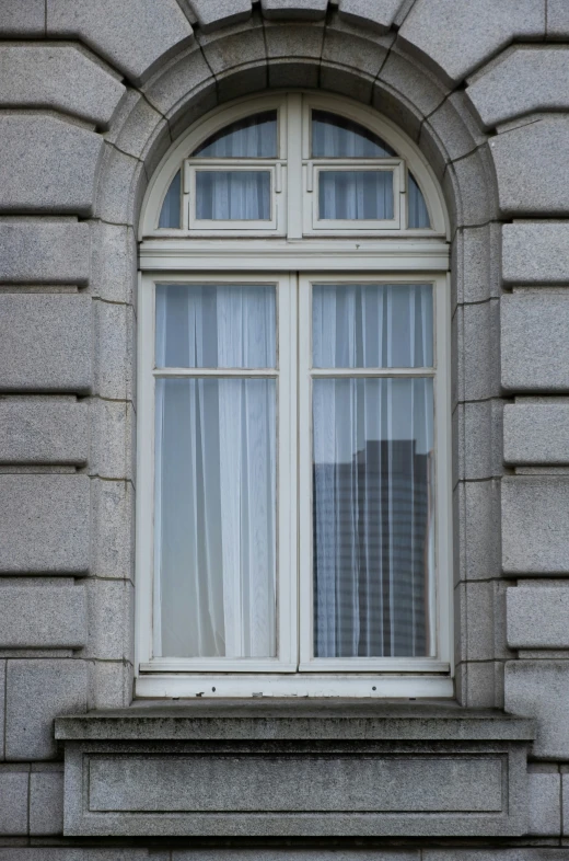 an old, arched window in a stone building