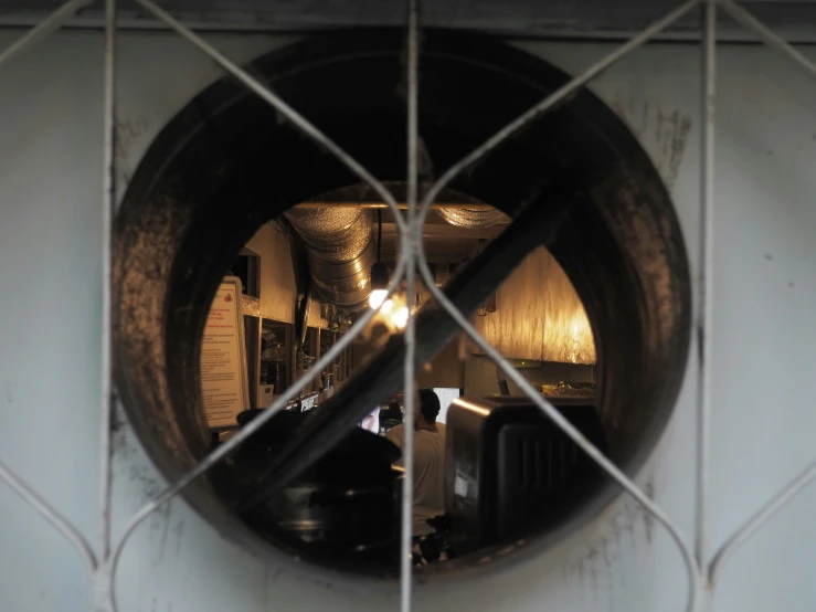 a circular mirror showing the reflection of a bar