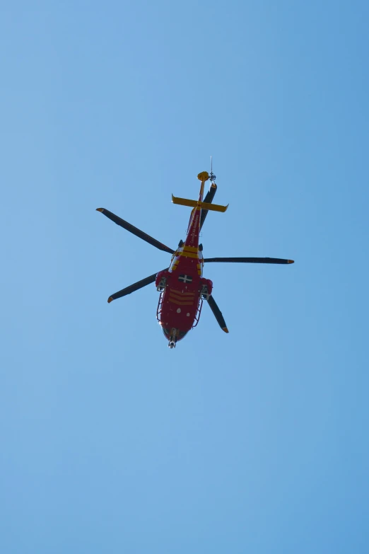 a helicopter flying through the sky on a clear day