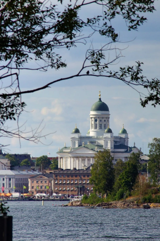 a big building with a dome above water