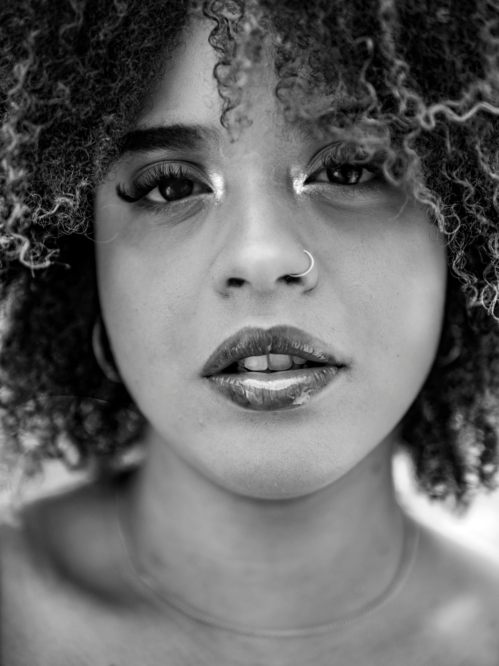 black and white image of a woman with a frizzy afro