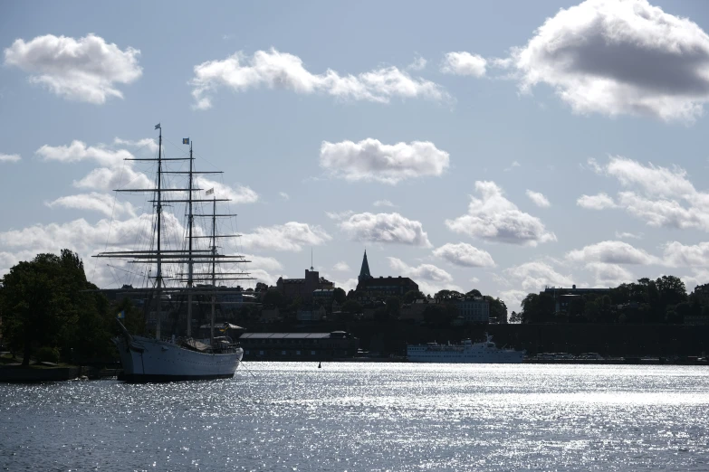 a tall sailboat out in the ocean