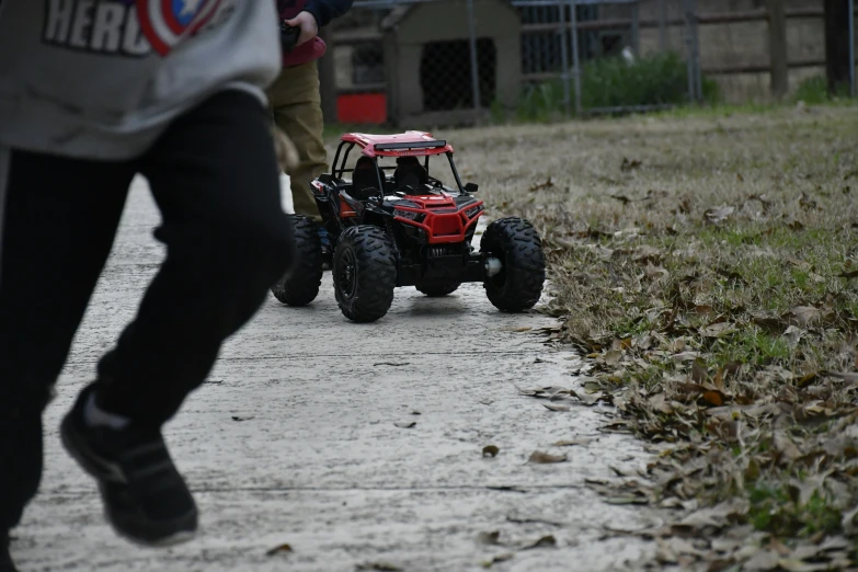 a remote control buggy driving down a road