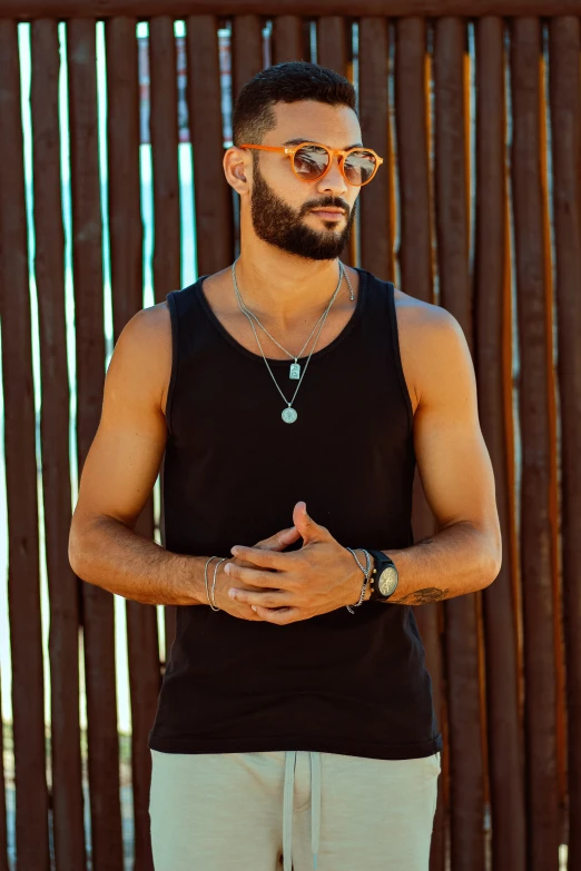 man wearing a black tank top looking at the camera