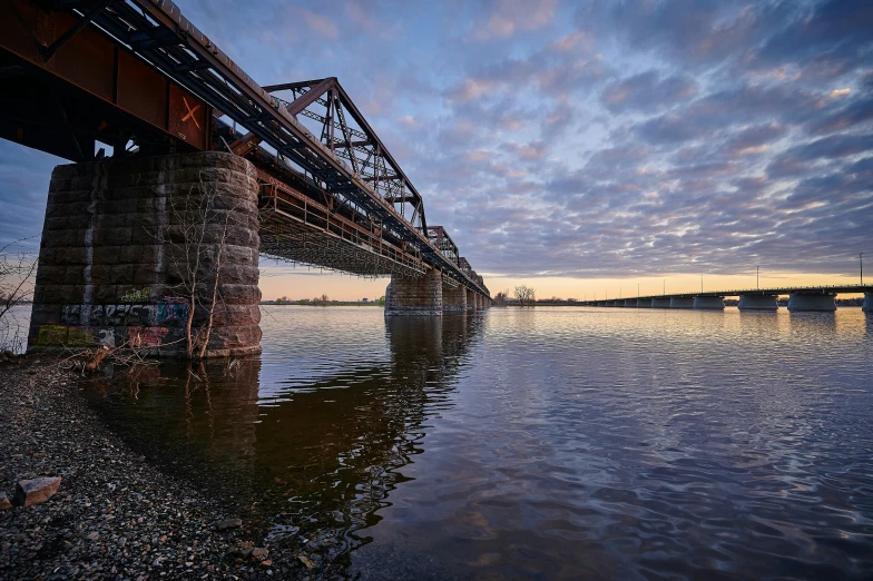 a bridge spanning over water in the middle of the day