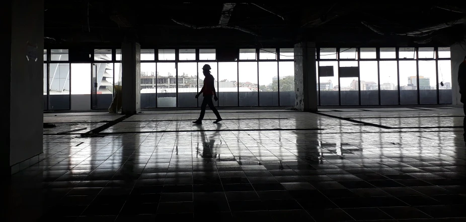 a person walking on a tiled floor inside of a building