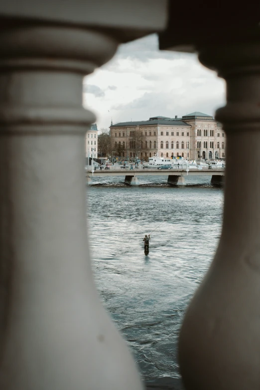 the view of a body of water and a man walking