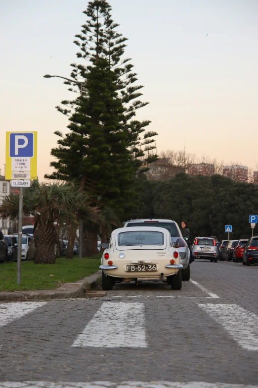 a car is driving down the street in front of another vehicle