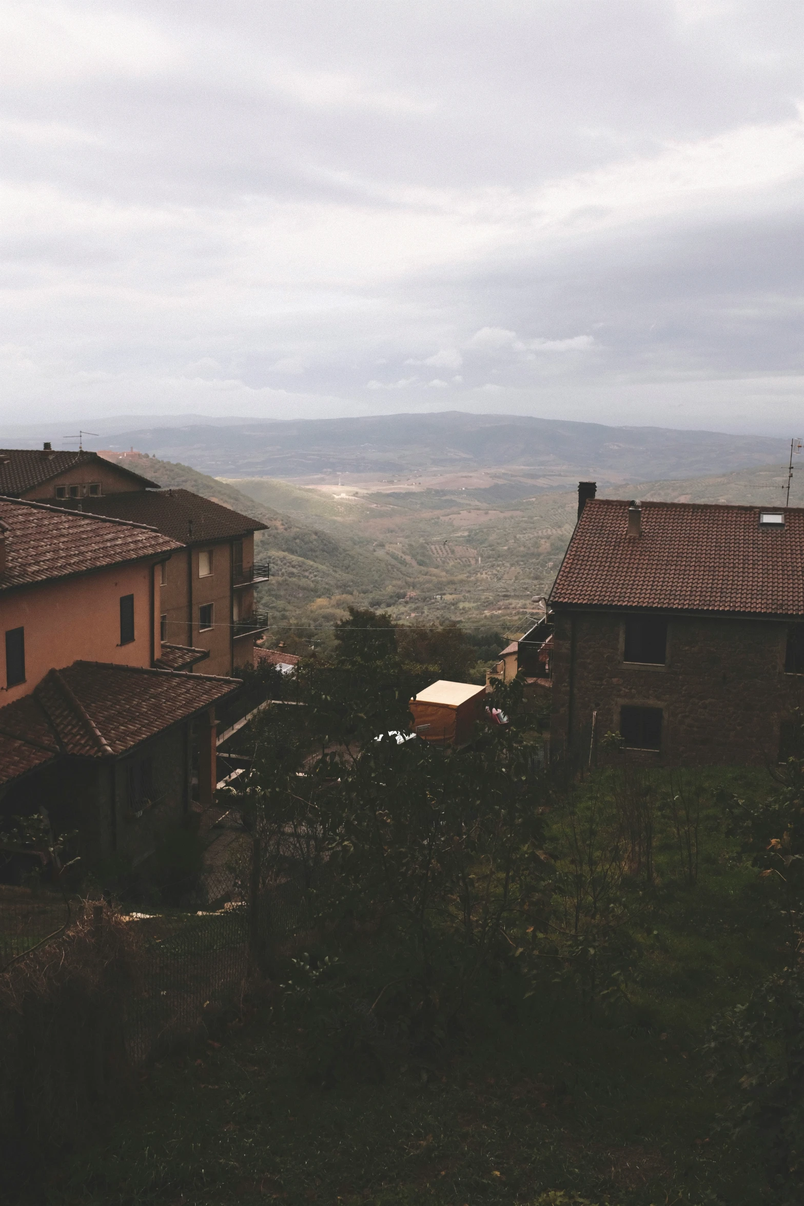 two buildings sitting on top of a hill