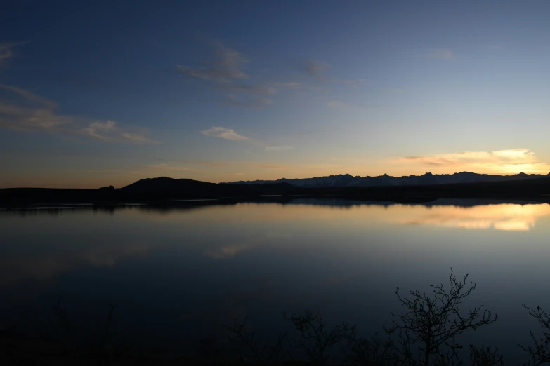 a large body of water that has a mountain in the background