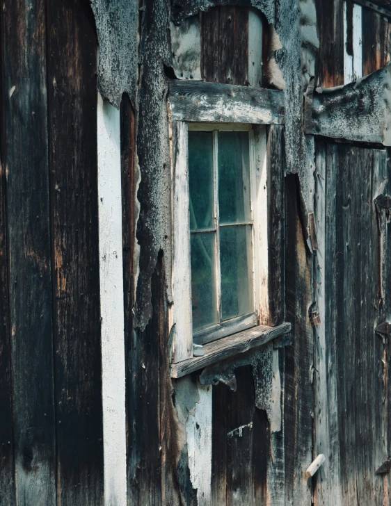 a peeling exterior wall with some windows