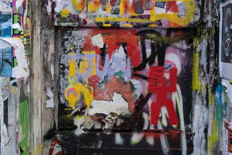 an old, peeling door has graffiti on it