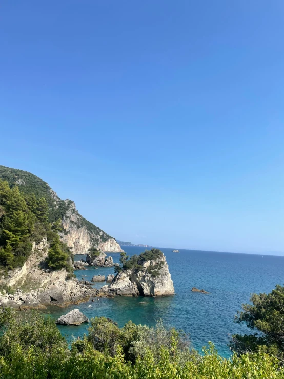 a view of the sea from a path leading to a cliff