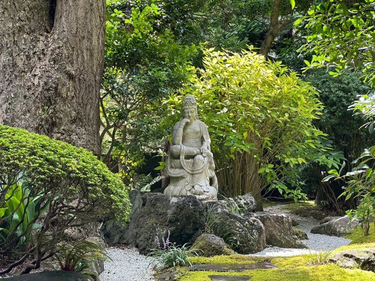 a buddha statue sitting on a small table