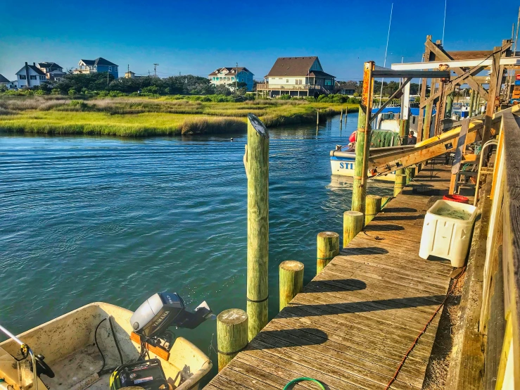 a small boat sits at the end of a dock