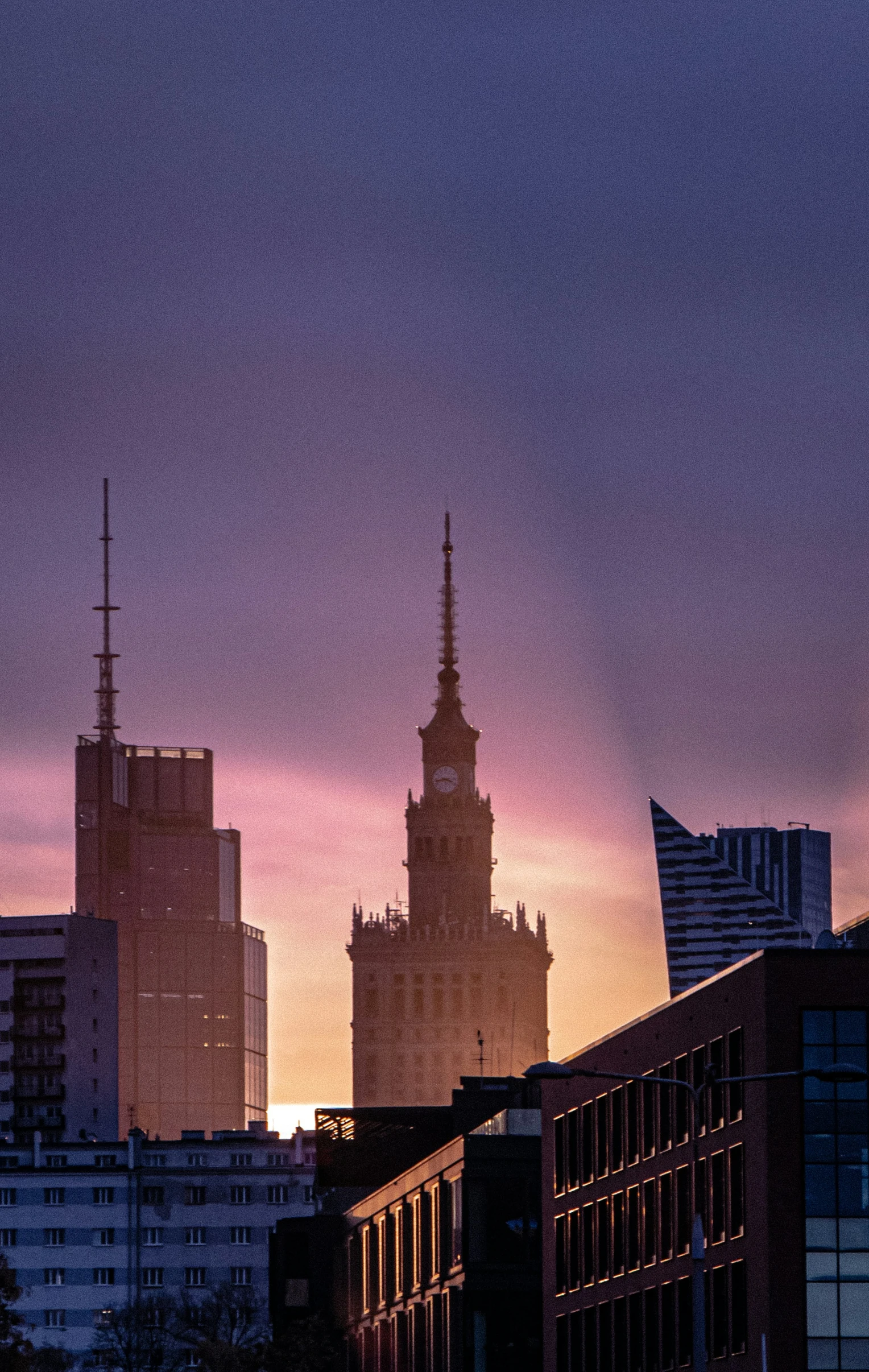 the view of a city skyline is shown at sunset