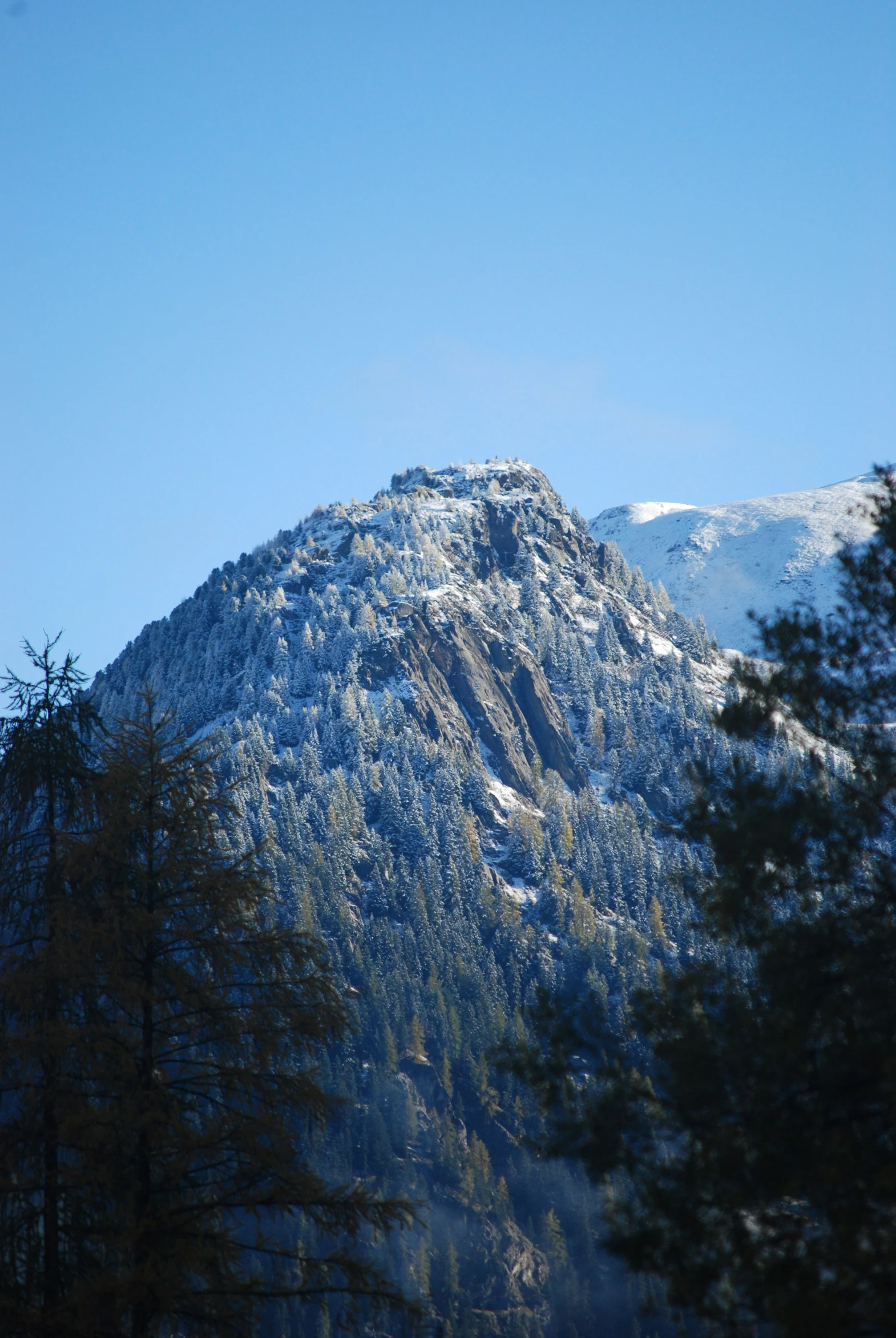a mountain covered in snow in the middle of winter
