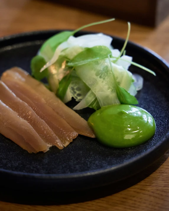 a plate topped with sushi next to a pile of lettuce