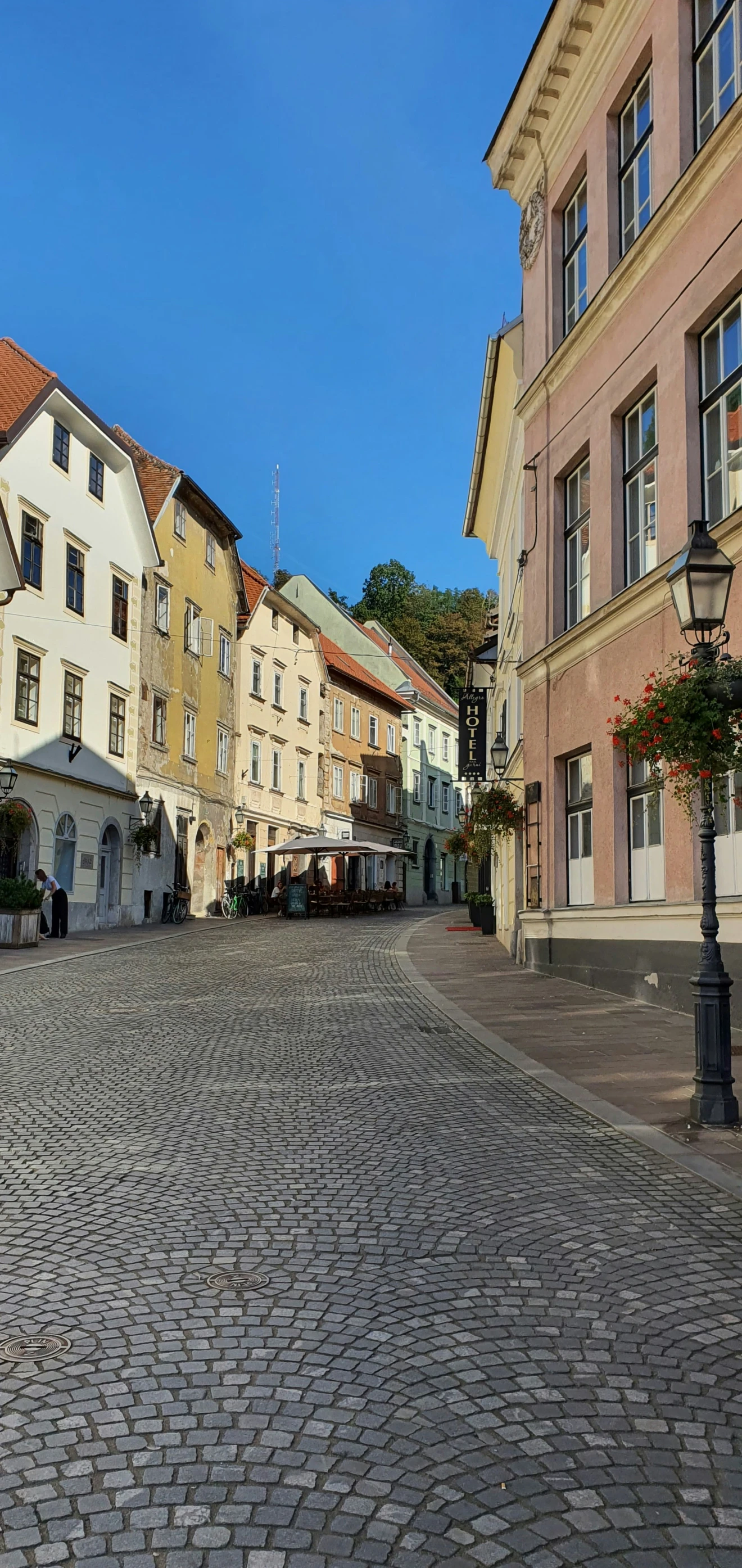 the cobblestone street is lined with old buildings