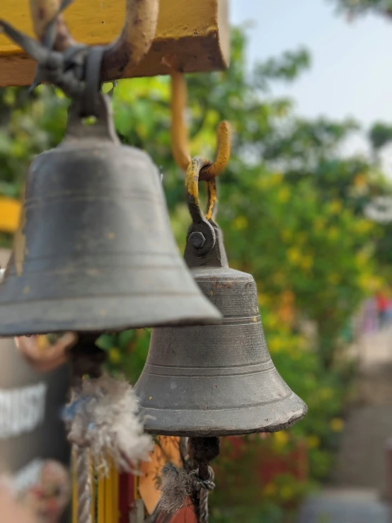 the bells of an antique - looking bell are hung up