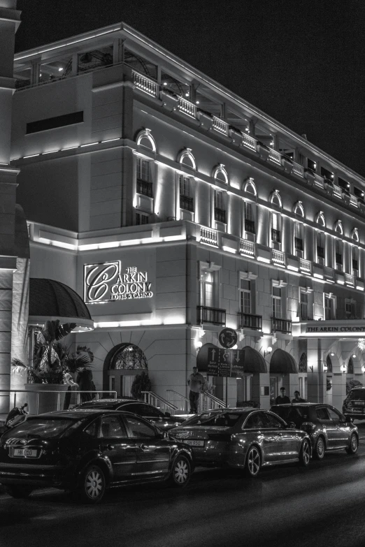 an elegant building is lit up at night