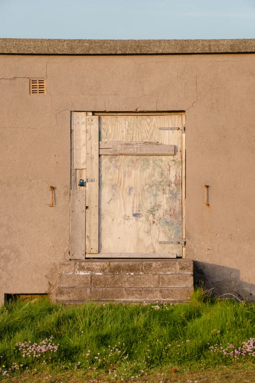 a door is open by the side of a stucco building