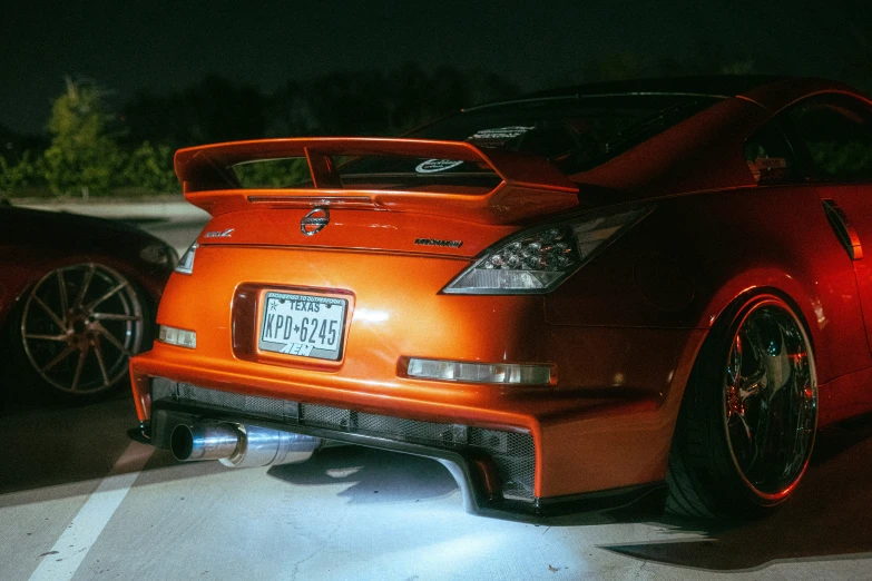 a car sits in the dark near the curb