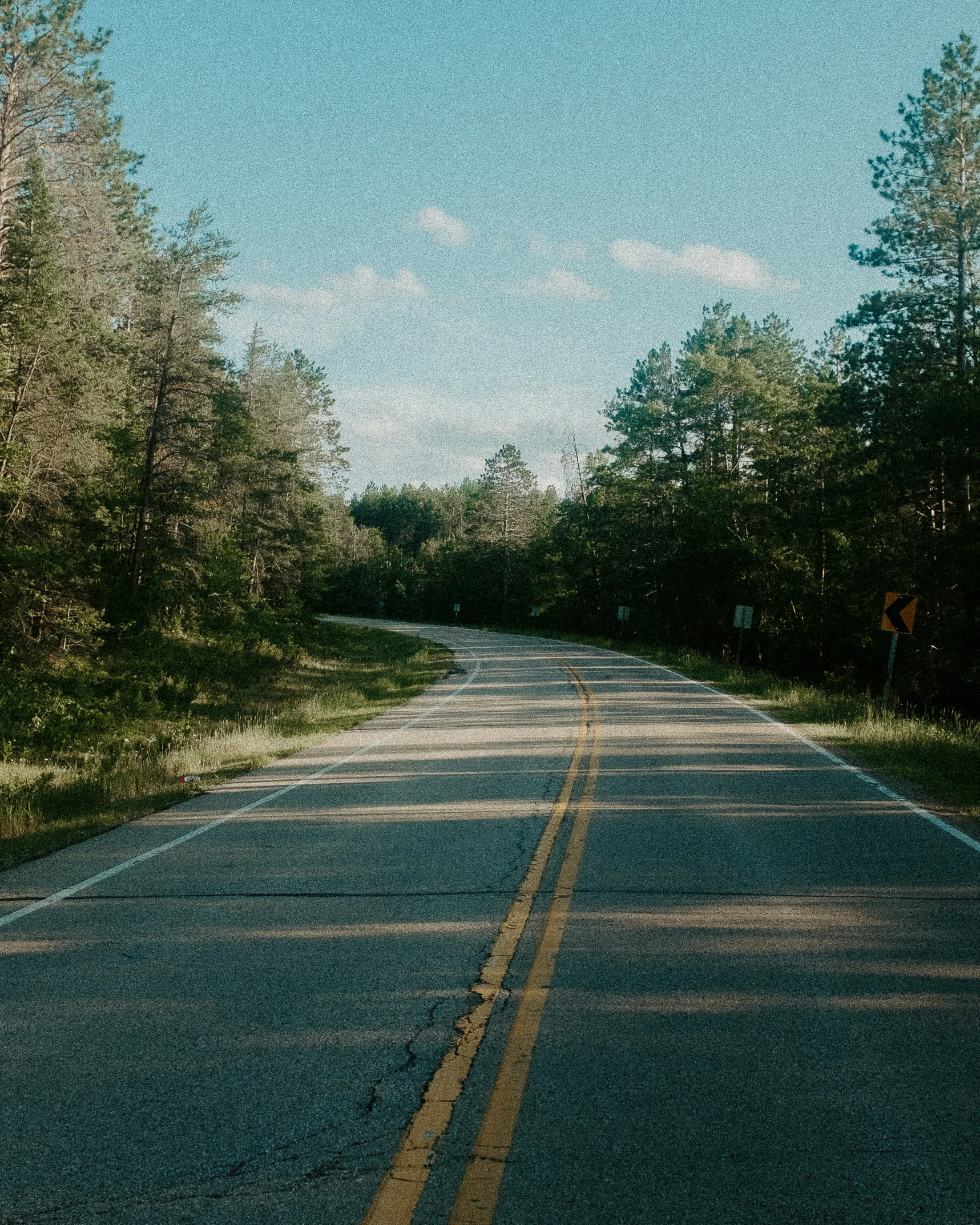 an empty road on a cloudy day in the wilderness