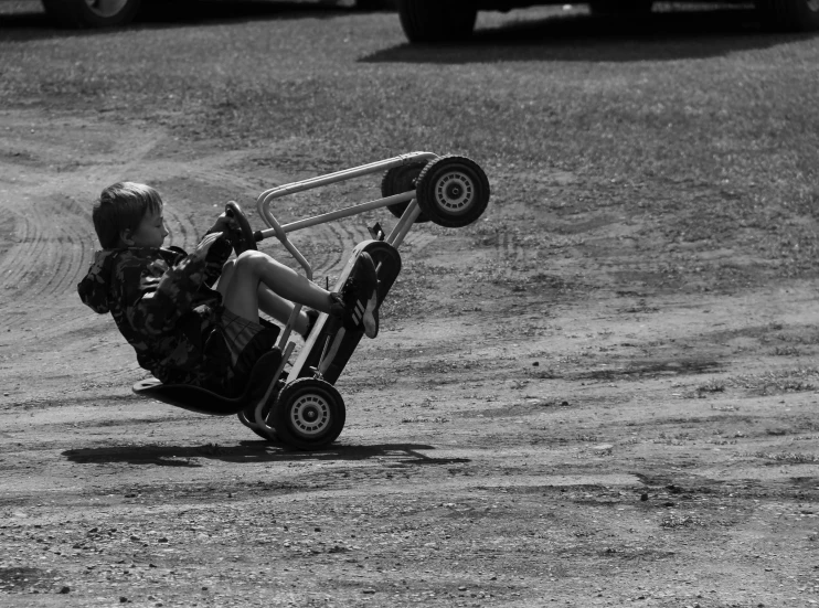 a young person performing stunts on their small vehicle