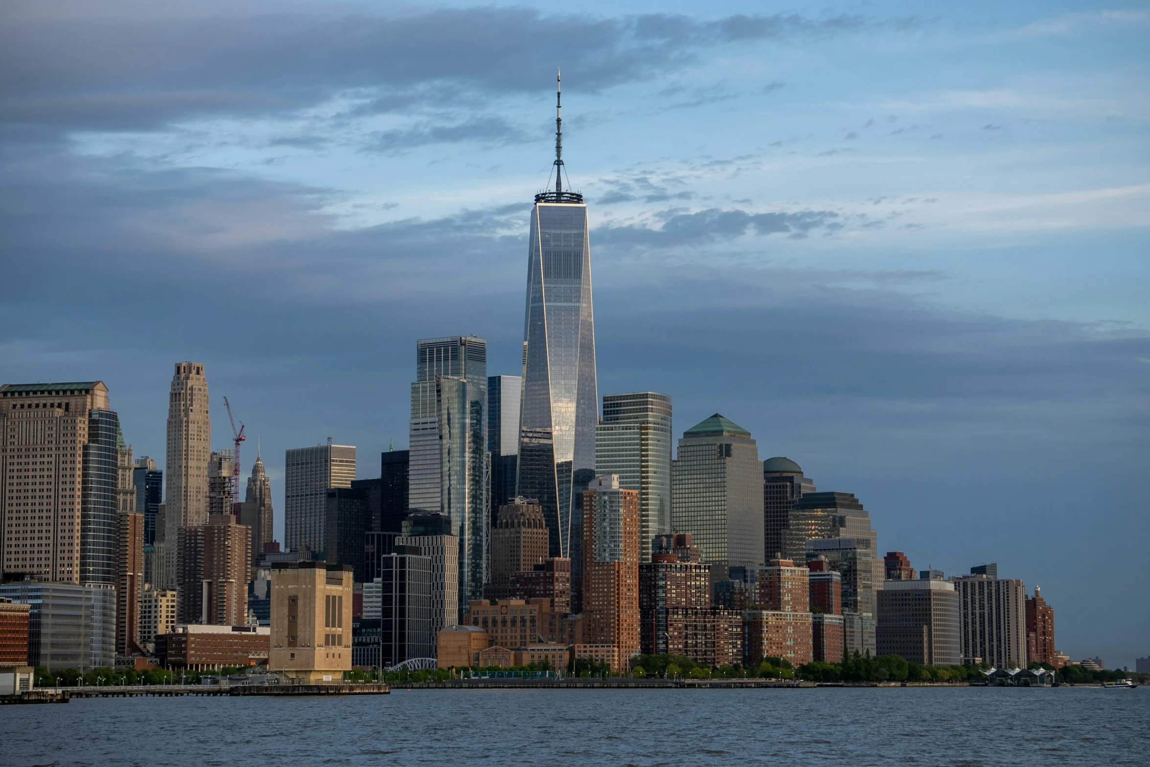 the skyline of a very large city is seen at twilight