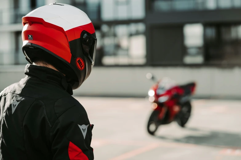 there is a man wearing a helmet standing on the street