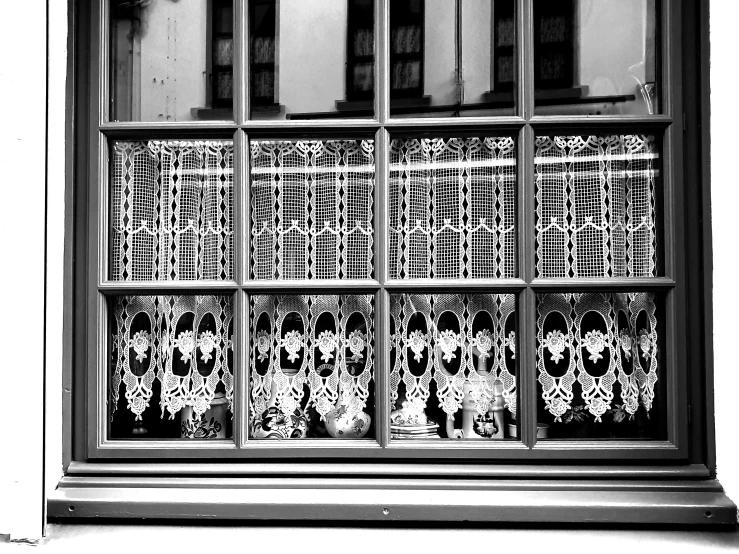 black and white pograph of several dogs behind a window