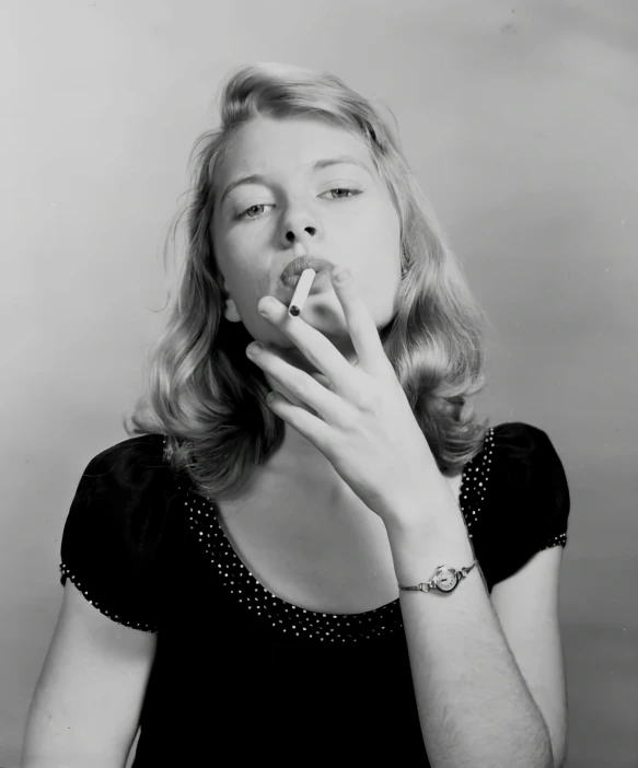 black and white pograph of a woman smoking a cigarette