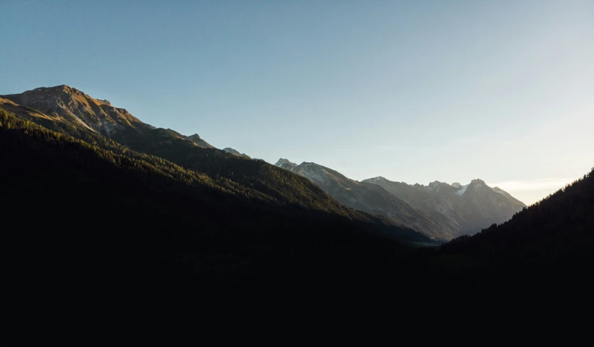 a view of the mountains in the afternoon light