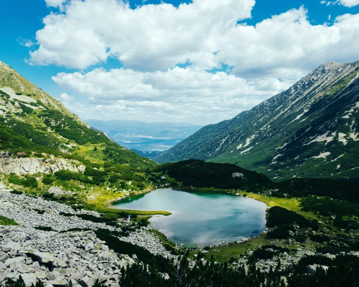 two large mountains and a small lake