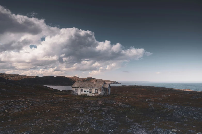 the house is in the field near the water