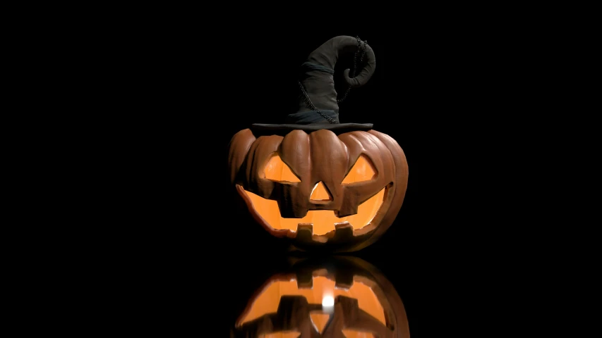 a lighted halloween pumpkin sitting on top of a reflective table