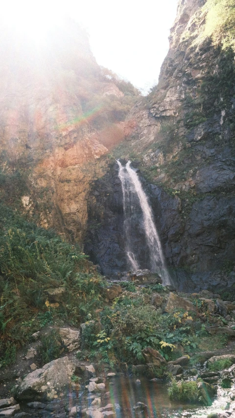 a small waterfall coming into a canyon