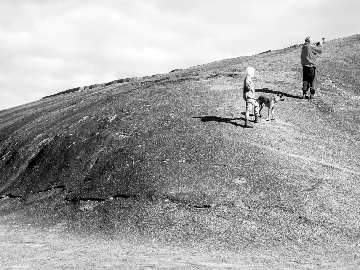 a man and a woman walking up a hill