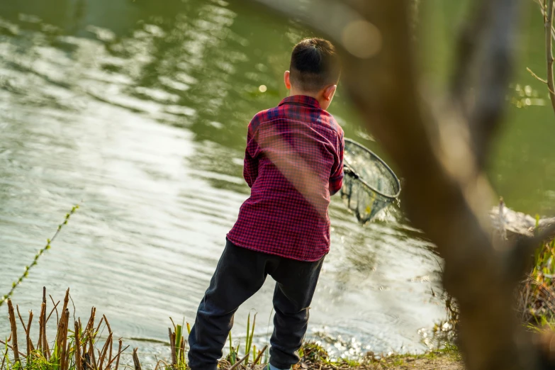 a person by the water holding a tennis racket