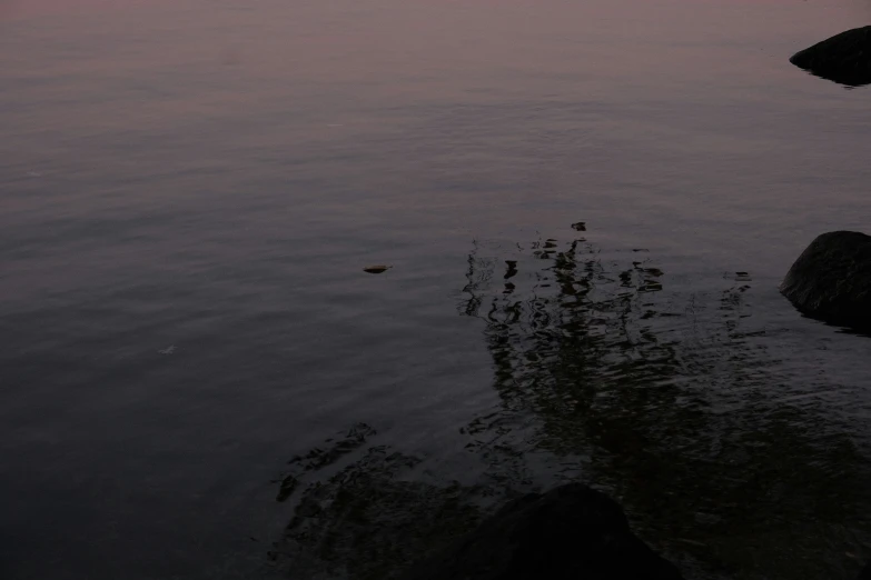 the sky is reflecting in the calm water