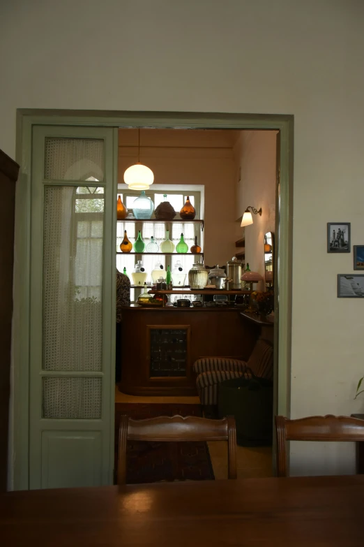 the door to an open bar with glass doors