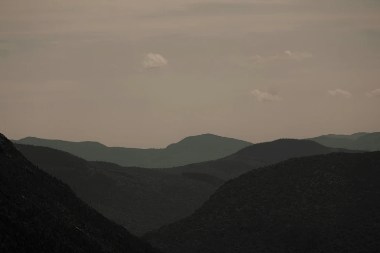 the view of hills and valleys is seen at dusk